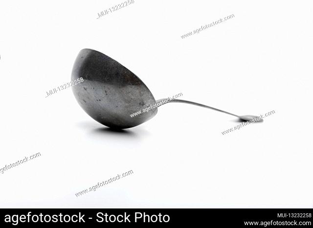 Old silver ladle against a white background