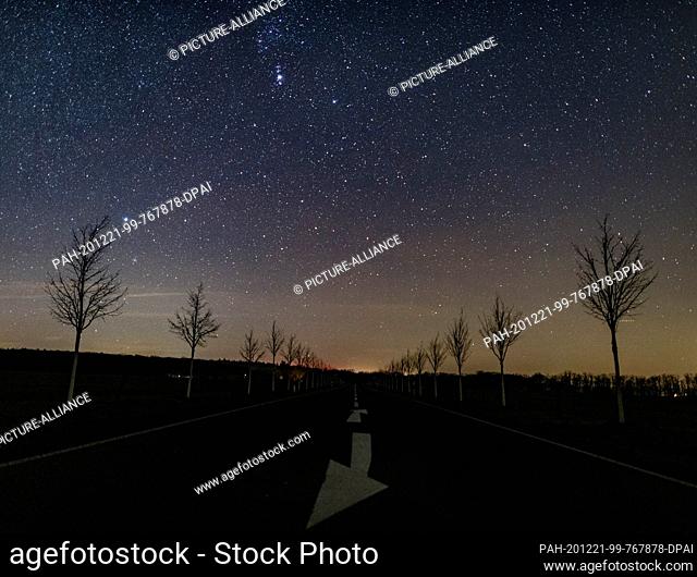18 December 2020, Brandenburg, Falkenhagen: View of a small part of the Milky Way in the starry night sky above a street in the district of Märkisch-Oderland