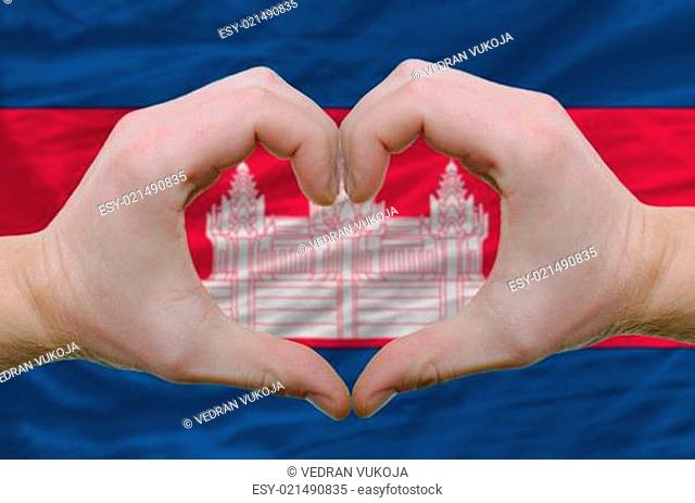 Heart and love gesture showed by hands over flag of cambodia bac