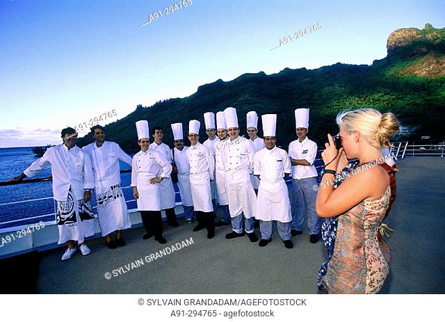 Chefs and cooks posing for picture at deck of MS Paul Gauguin. French Polynesia