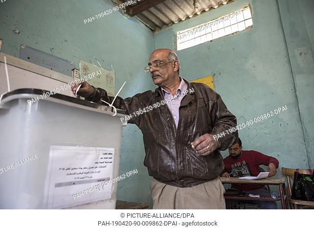 20 April 2019, Egypt, Cairo: A man casts his ballot on the first day of the national referendum on the constitutional amendments extending the presidential term...