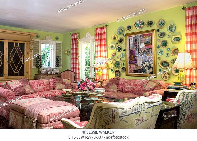LIVING ROOMS: Bright green walls with bright raspberry accent colors, collection displays of plates, toile fabric sofas, bergere chair backs to camera