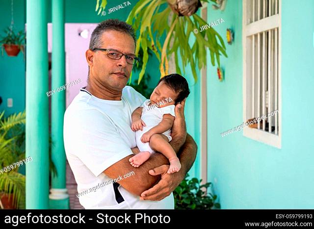 Photo of a baby in the arms of a man