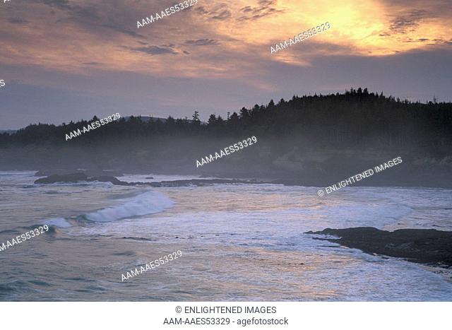 Clouds at sunrise over waves breaking on the coast at Rocky Creek State Scenic Area, near Newport, Oregon