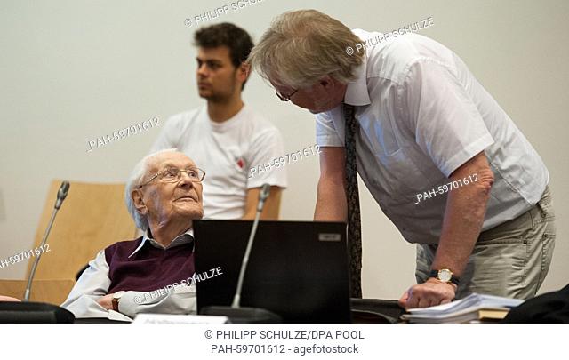 94-year-old defendant and German former SS officer, Oskar Groening (L) also known as the 'bookkeeper of Auschwitz' speaks to his attorney Hans Holtermann (R) in...