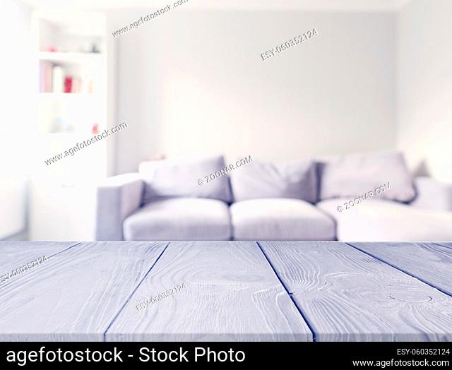 gray wooden table front blur white sofa living room