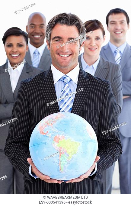 Ambitious business team showing a terrestrial globe against a white background