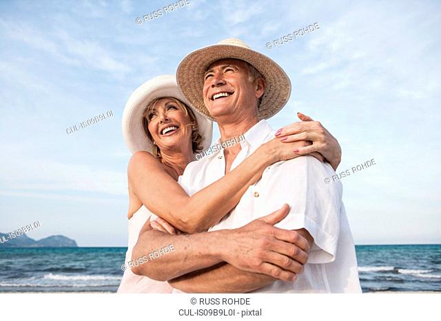 Couple hugging on beach, Palma de Mallorca, Spain