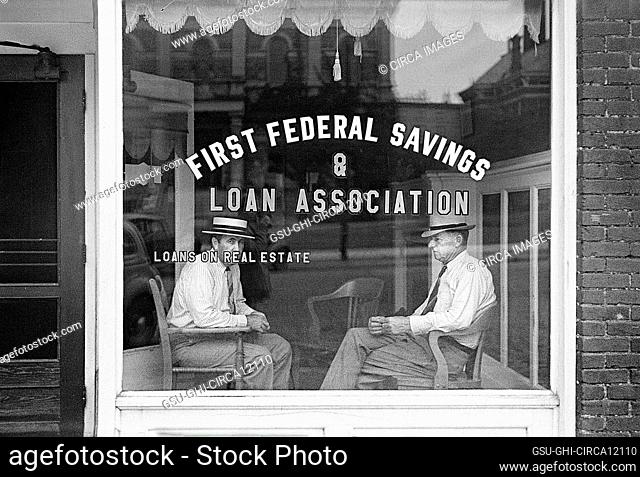 Two men sitting in window of First Federal Savings and Loan Association office, Marion, Ohio, USA, Ben Shahn, U.S. Farm Security Administration, July 1938