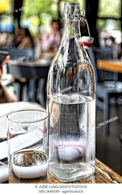Bottle and Glass of Water on a New York City Restaurant Table