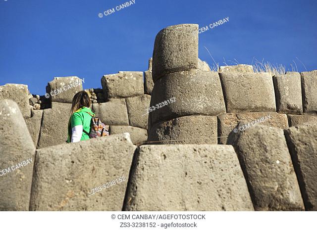 Visitor at the The Saqsaywaman archaeological complex, a massive fortress of the Incas, overlooking the Inca navel of Cusco, Peru, South America