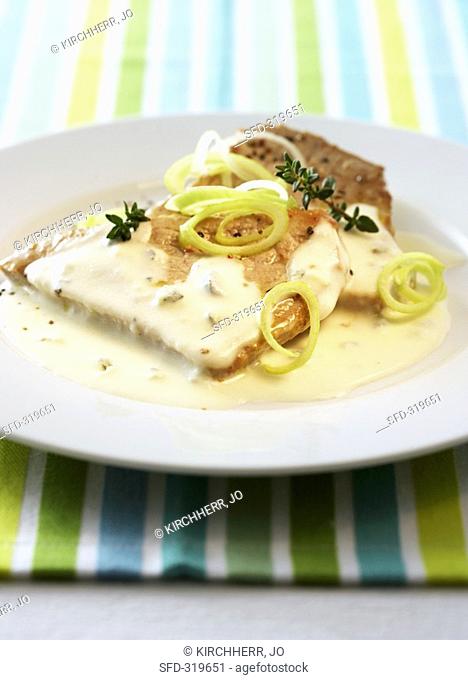 Pork steak with cream sauce and spring onions