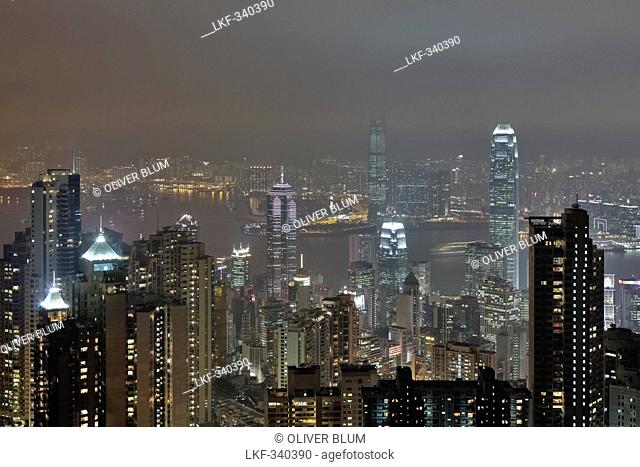 View of Hong Kong from Victoria Peak towards Victoria Harbour and Kowloon and the illuminated skyscrapers at night, Hong Kong, China
