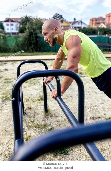 Muscular man exercising outdoors