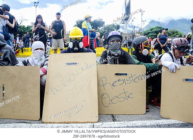 Warriors waiting. Opposition protesters assembled on the Francisco Fajardo motorway, near Francisco de Miranda Air Force Base in La Carlota