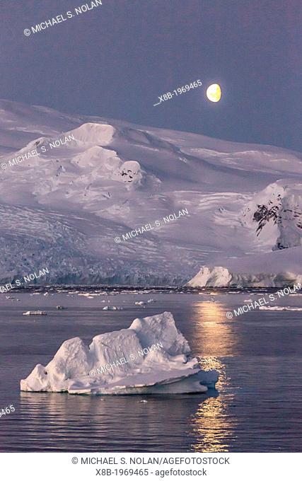 Moonrise over icebergs in the Gerlache Strait, Antarctica, Southern Ocean