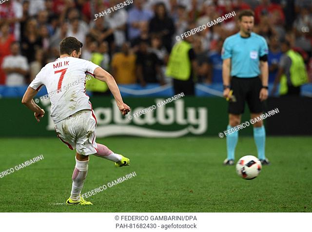 Arkadiusz Milik of Poland scores in the penalty shoot-out during the UEFA EURO 2016 quarter final soccer match between Poland and Portugal at the Stade...