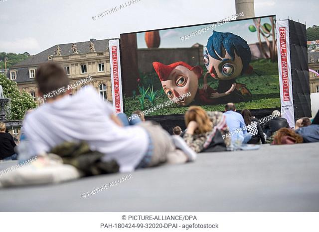24 April 2018, Germany, Stuttgart: Visitors watching ""My Life as a Courgette, "" the first film running on the open-air stage of the International Festival of...