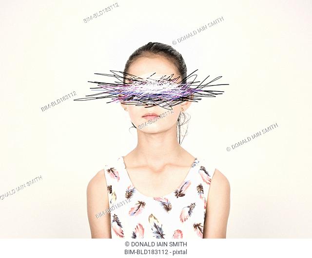 Mixed race girl with eyes scribbled out