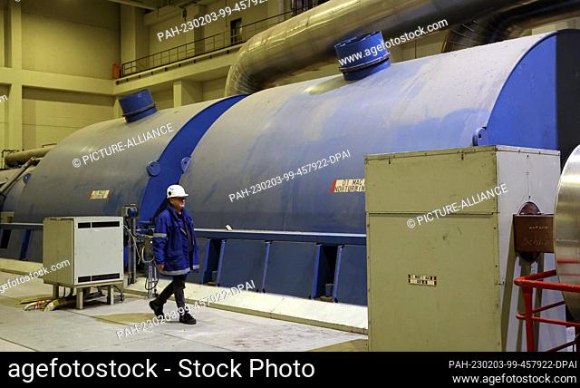 PRODUCTION - 02 February 2023, Mecklenburg-Western Pomerania, Rostock: Holger Kirsche, production manager, walks through the turbine engine house at the...