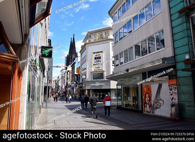 23 May 2021, North Rhine-Westphalia, Cologne: The shopping street Hohe Strasse in Cologne, in the background the Cologne Cathedral