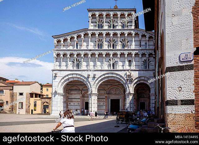 romanesque facade and bell tower of st. martin cathedral in lucca, tuscany. it contains most precious relic in lucca, holy face of lucca (italian: volto santo...