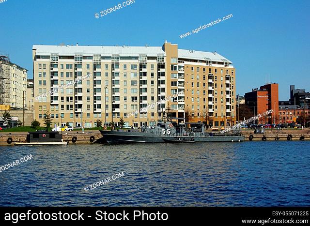 May sunny day and walk around the city, embankment and moored warship