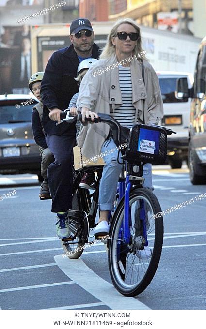 Naomi Watts and Liev Schreiber take their children to school on bikes. Liev rides a bike with his two sons, Samuel and Alexander