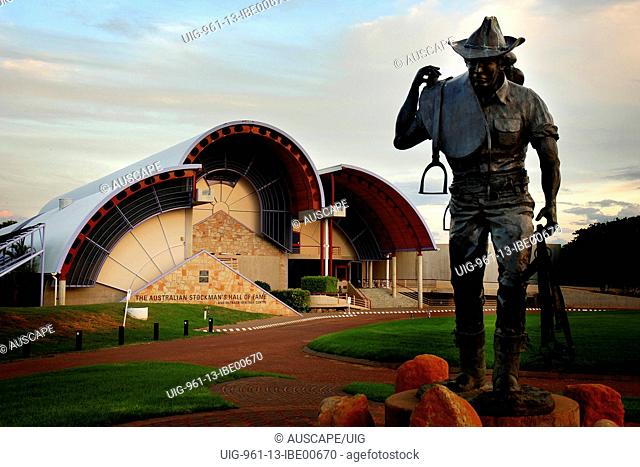 The Australian Stockman’s Hall of Fame with statue of stockman carrying saddle in foreground Longreach, Queensland, Australia