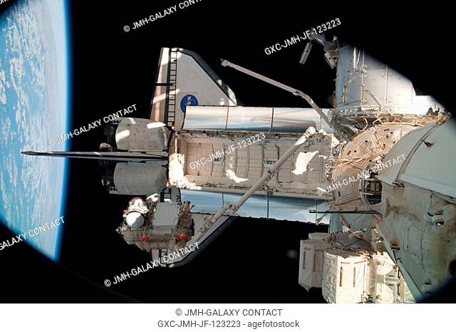 In the grasp of the station's robotic Canadarm2, the Russian-built Mini-Research Module 1 (MRM-1) is moved to be permanently attached to the Earth-facing port...