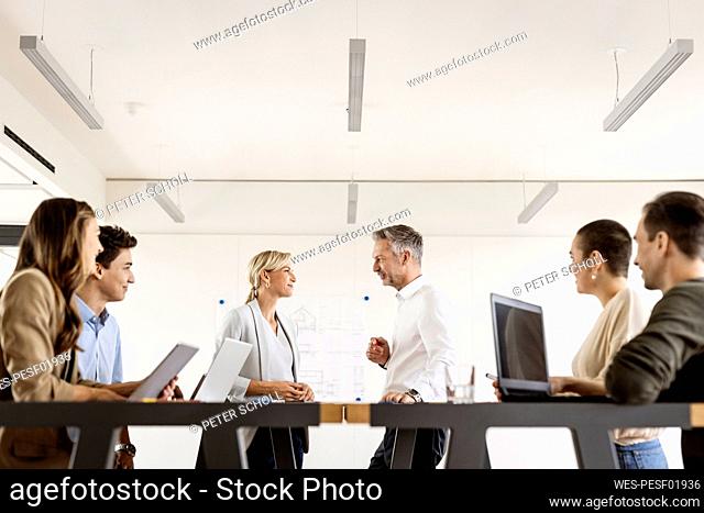 Businesswoman and businessman leading a meeting in office