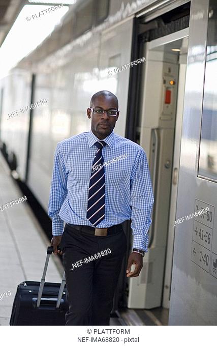 A businessman with a bag at a train station Stockholm Sweden