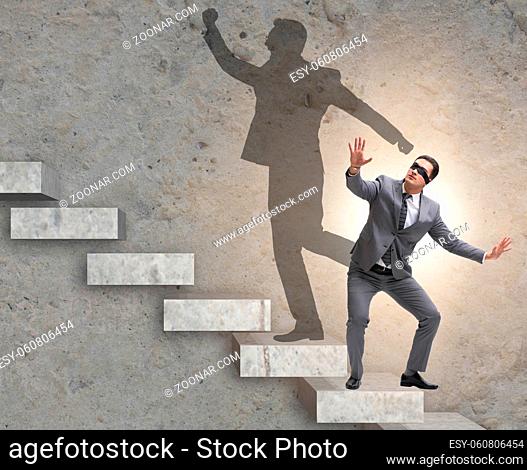 The businessman and his shadow in business concept