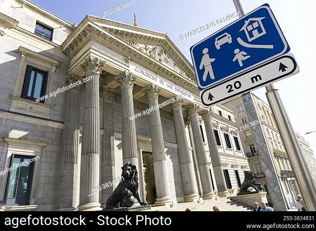 Traffic sign 'residential area'. Palacio de las Cortes is a building in Madrid where the Spanish Congress of Deputies meet