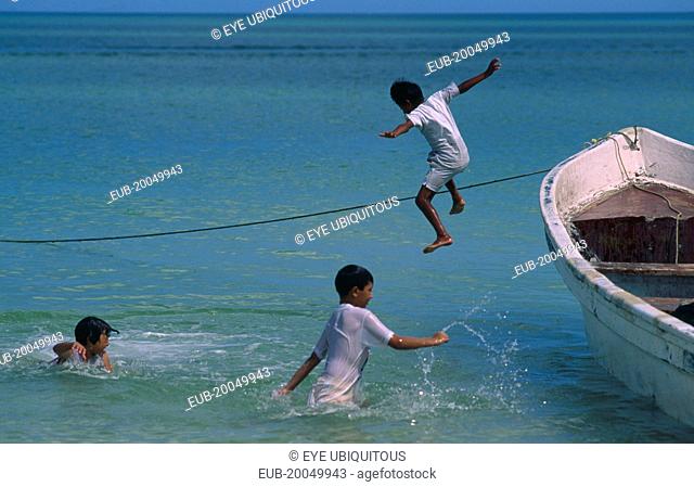 Gulf of Mexico. Children jumping from fishing boat into the sea