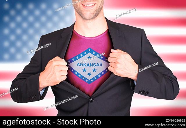 Businessman opening suit to reveal shirt with state flag (USA), Arkansas