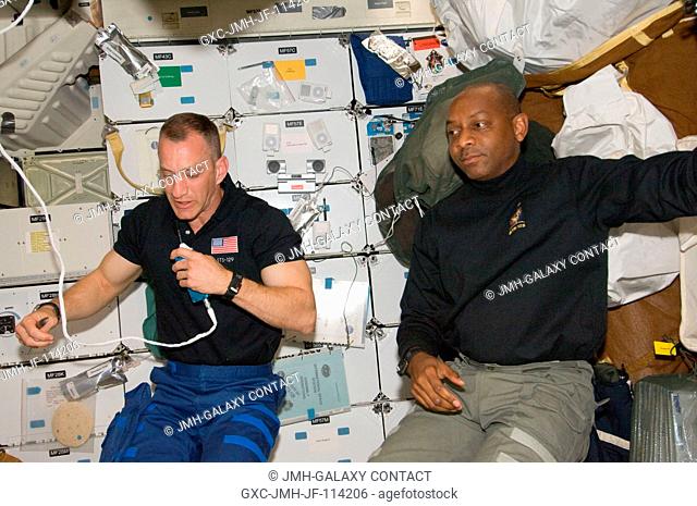 Astronauts Charles O. Hobaugh (left), STS-129 commander; and Robert L. Satcher Jr., mission specialist, are pictured on the middeck of Space Shuttle Atlantis...