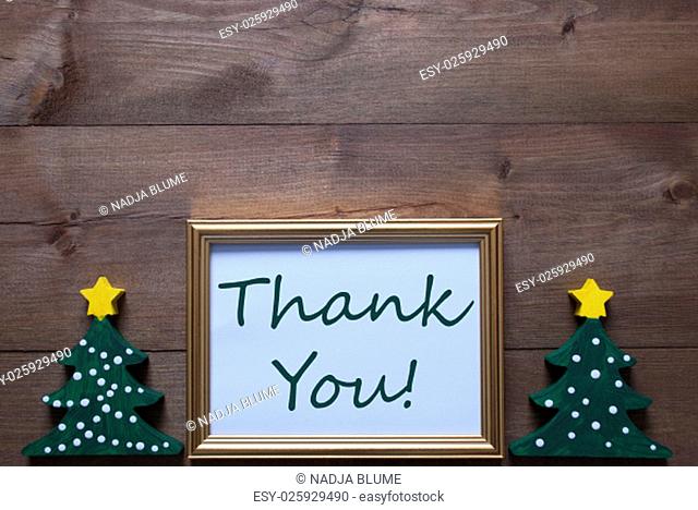 One Golden Picture Frame With Two Green Christmas Tree. English Text Thank You. Christmas Card For Seasons Greetings. Christmas Decoration With Brown Wooden And...