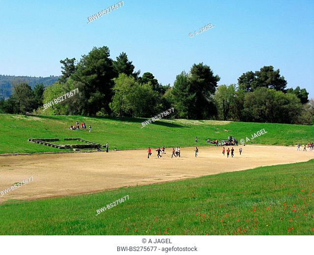 tourists running in the ancient stadium of Olympia, Greece, Peloponnes, Olympia