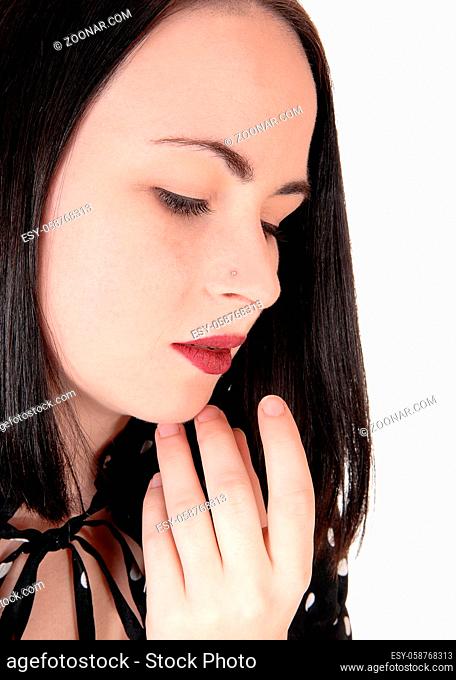 A close up image of the face of a gorgeous woman with her eyes closed and some finger on her chin, isolated for white background