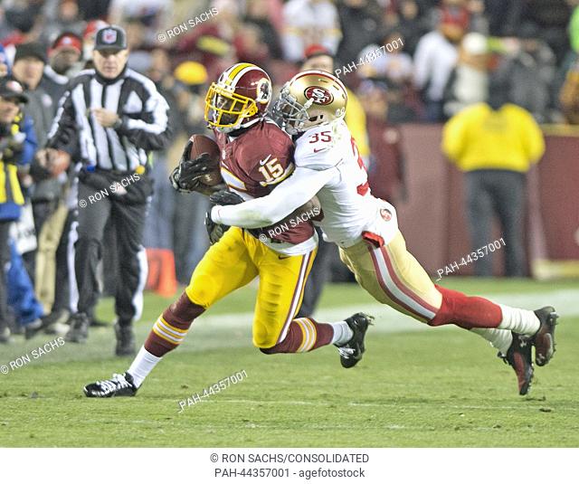 Washington Redskins wide receiver Joshua Morgan (L) is tackled by San Francisco 49ers safety Eric Reid (R) in second quarter action at the FedEx Field in...