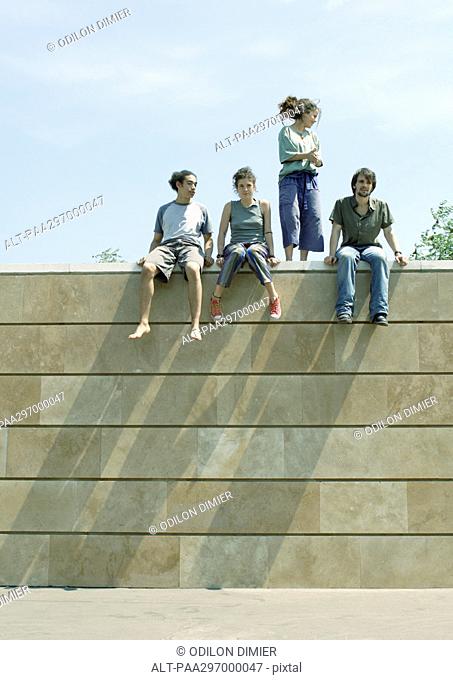 Young people on top of wall