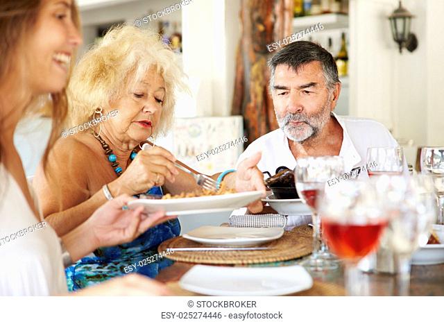 Multi Generation Family Enjoying Meal In Restaurant