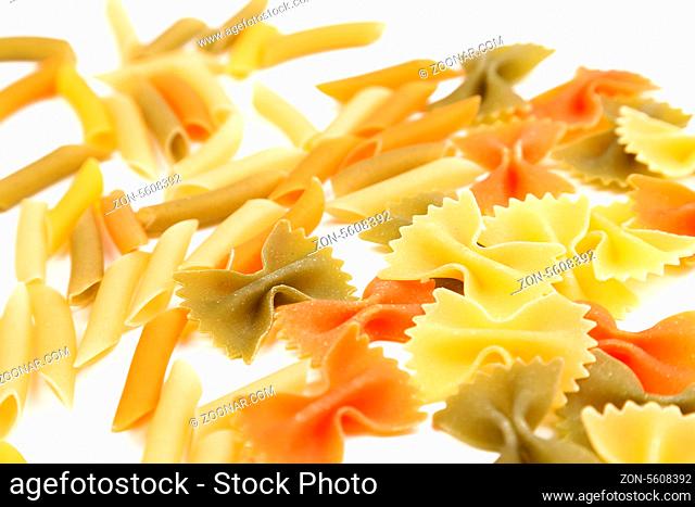 different pasta in three colors close-up on the white background