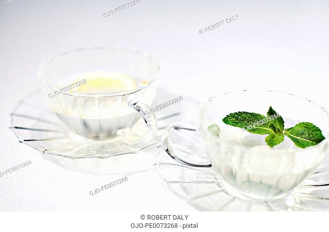 Lemon wedge and mint sprig in glasses of water