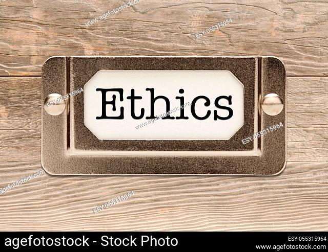 Ethics Metal File Label Frame on Wood Background