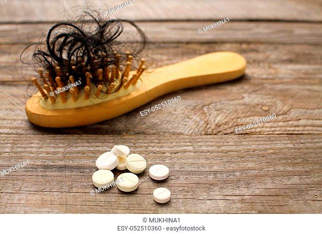 Fallen hair on comb and pill
