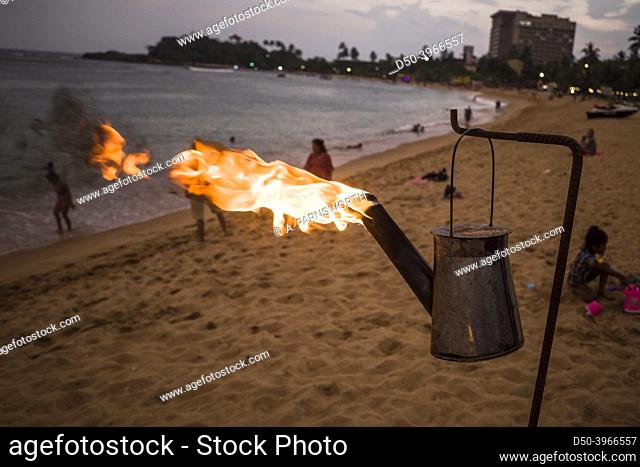 Unawatuna, Sri Lanka A kerosene lantern burns on the beach at sunset