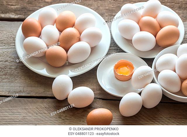 Raw chicken eggs on the wooden background