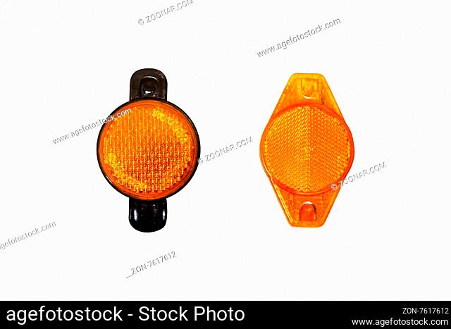 Close up detailed front view of orange headlights of a bicycle, isolated on white background